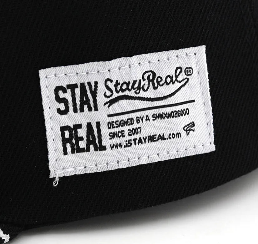 Cotton baseball cap with embroidered letters showing dome crown and adjustable back strap