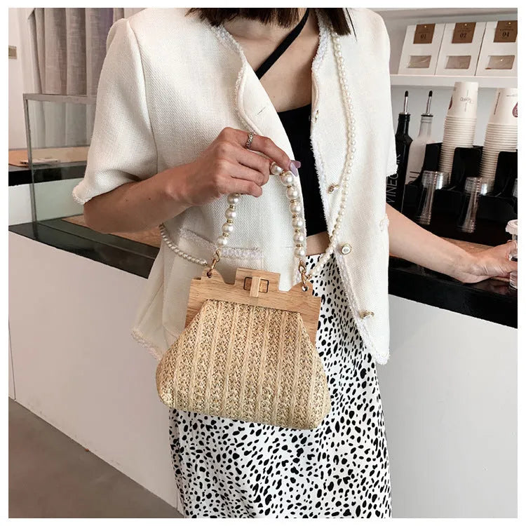Women's woven straw shoulder bag with pearl chain strap in horizontal square shape