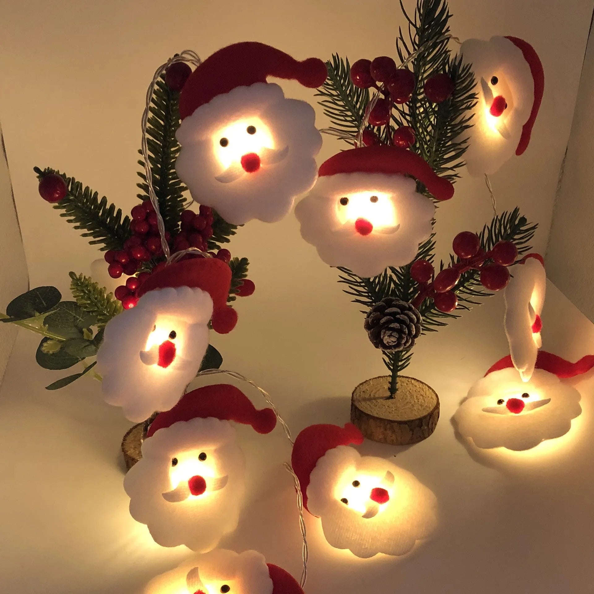 Warm white LED Christmas string lights with Snowman decorative figures on a green garland.