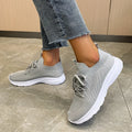 Women's low-top running shoes in Creamy White with mesh detailing and a flat rubber sole.