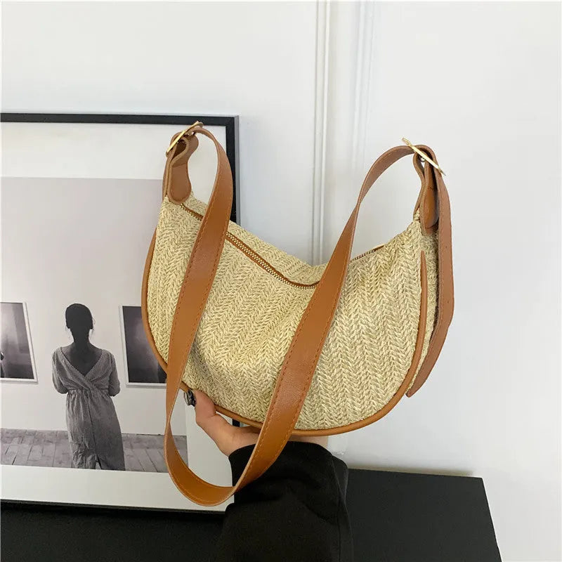 Women's knitted straw woven crossbody bag showing woven texture and internal phone compartment