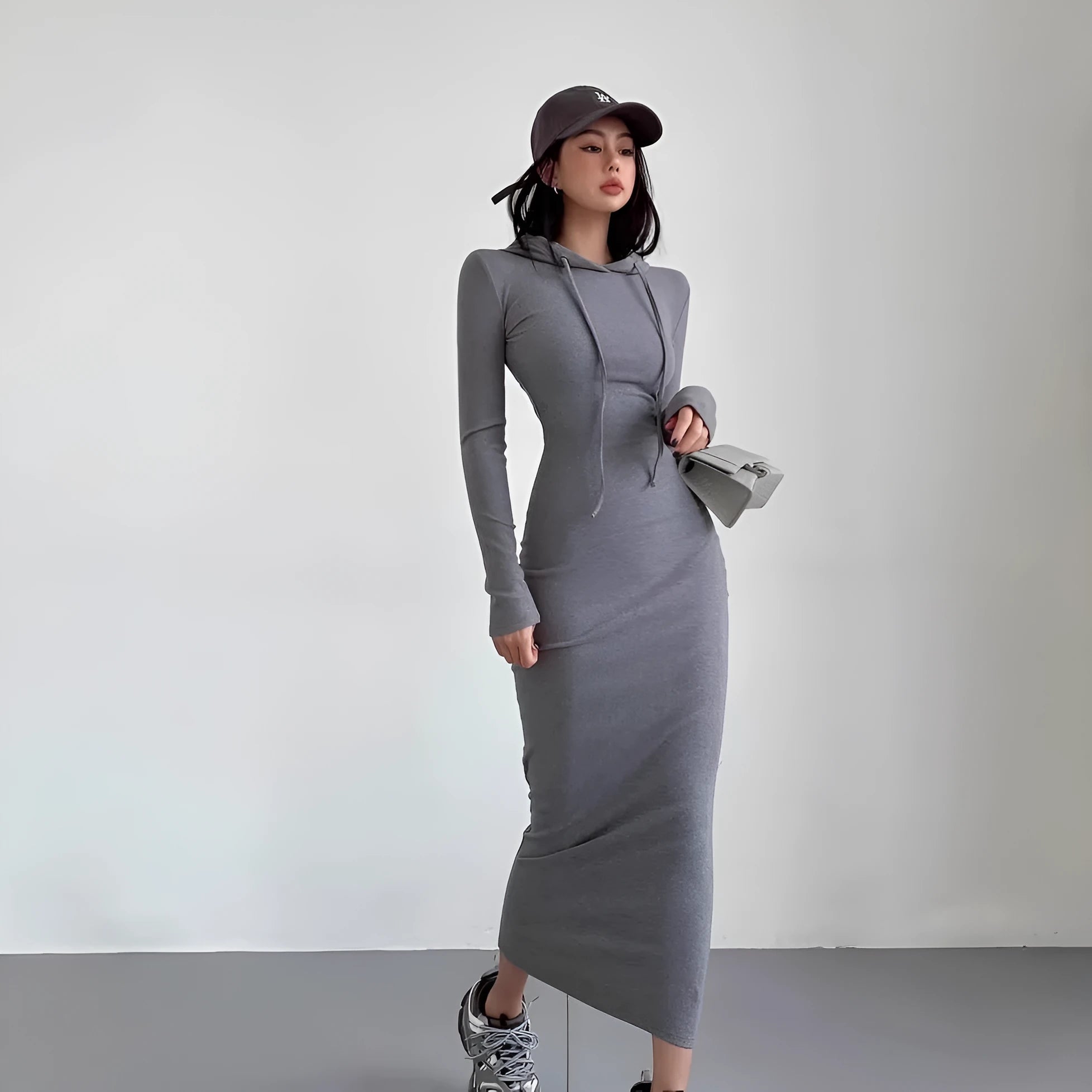 Women's grey hooded sheath dress with long sleeves and a high waist.