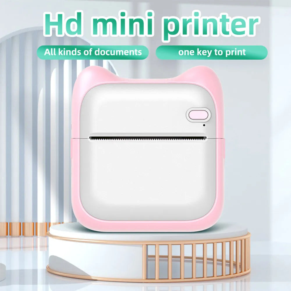 Pink mini pocket Bluetooth thermal printer on desk with USB cable, 90x45x82mm