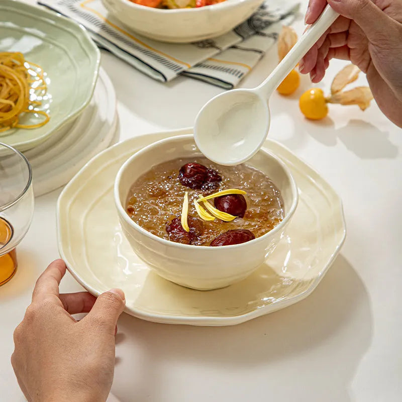 Seven-piece solid colour ceramic tableware set with modern Japanese style design on a table.