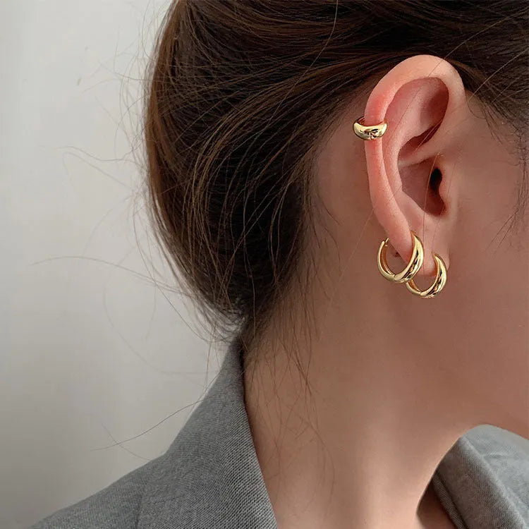 Geometric water drop earrings in gold or silver on a copper base, shown in small, medium, and large sizes.