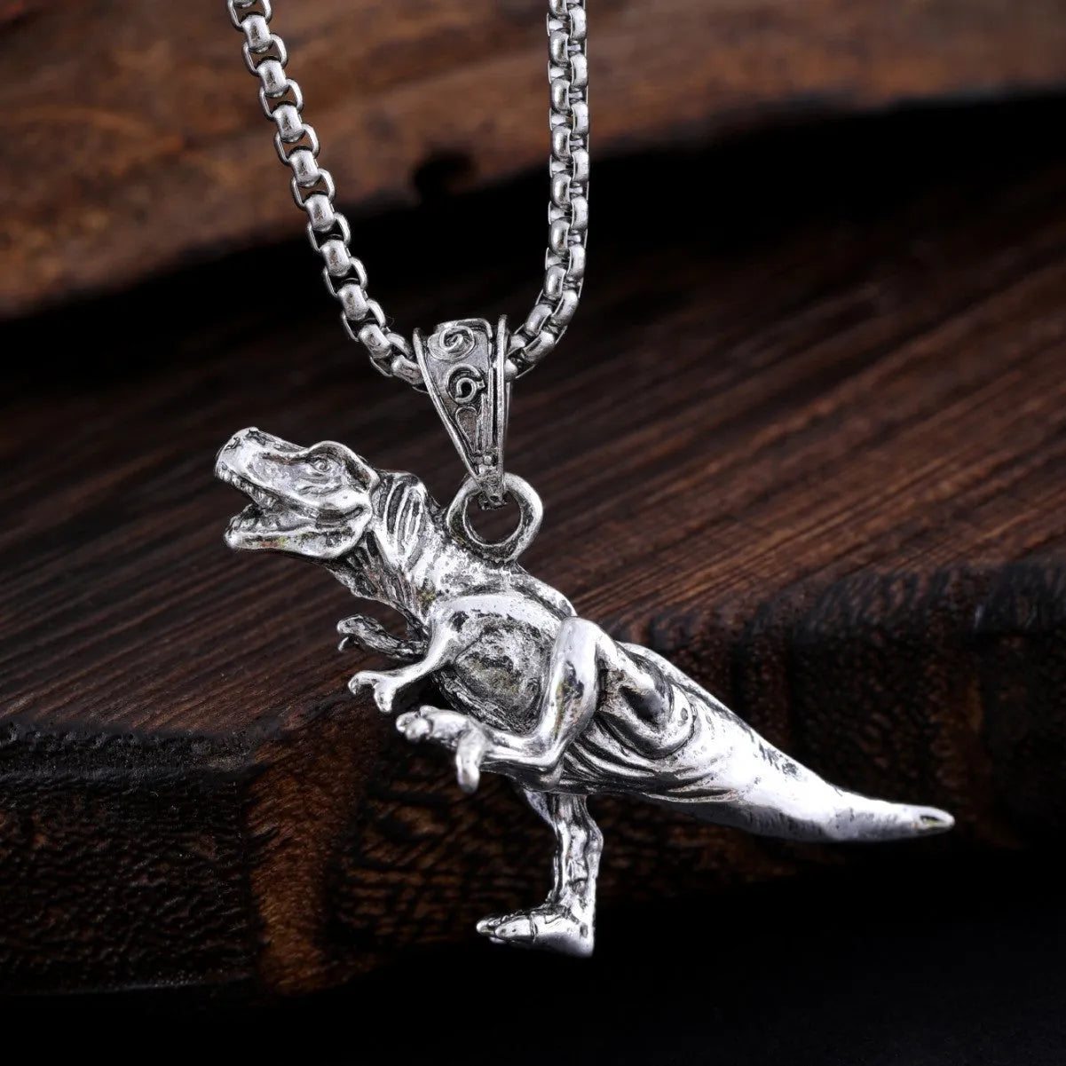 New hip hop style versatile titanium dinosaur pendant in silver tone on a neutral background