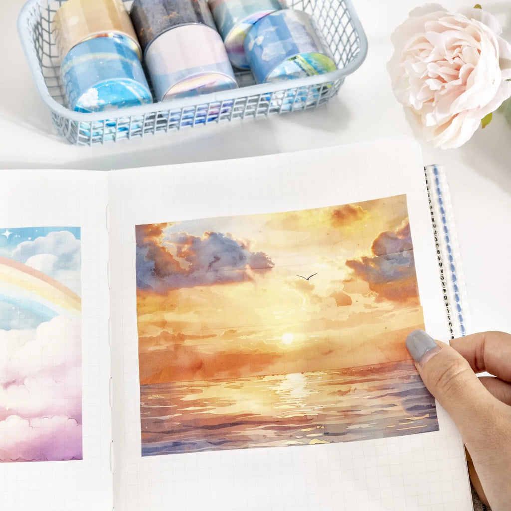 Japanese paper washi tape roll with celestial sky patterns including colourful clouds and twilight, 30mm width