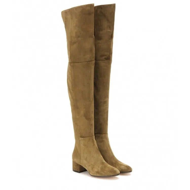 Women's grey suede over the knee flat boots with a low thick heel and pointed toe on a neutral background.