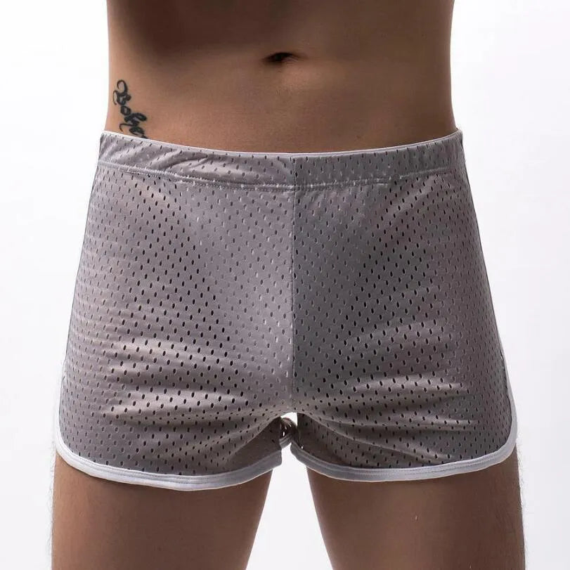 Men's knitted cotton three-point boxer shorts in black, grey, blue, and white colours laid flat.