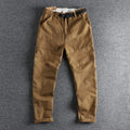 Men's khaki cotton work trousers with an adjustable N-I buckle belt on the waistband, shown with a 3D cut design.