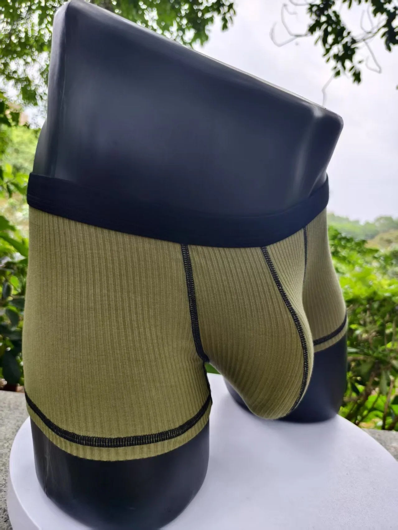 Men's solid colour breathable fibre boxer shorts shown in army green, demonstrating thin fabric and fit.