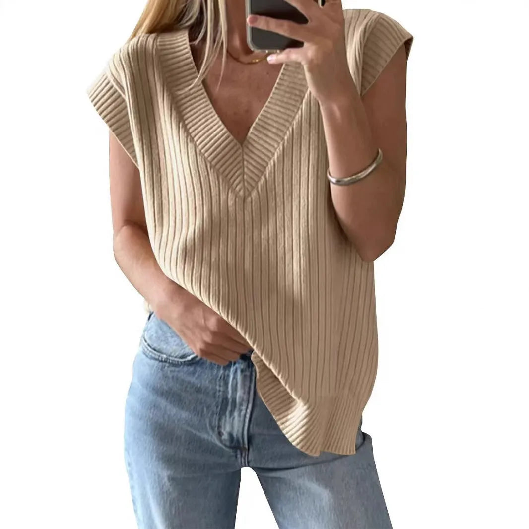 Camel and white loose v-neck sleeveless vest with striped or plaid pattern.