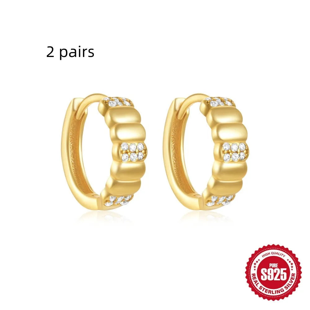 Sterling silver geometric stud earrings with round diamond accents in gold and silver electroplated finishes