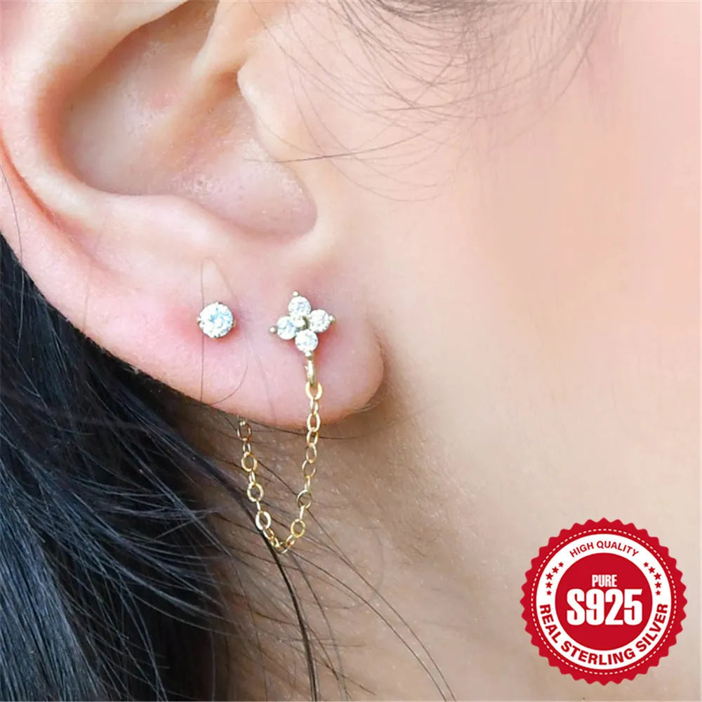 S925 sterling silver stud earrings with a floral motif and dangling gold-coloured tassel chain.