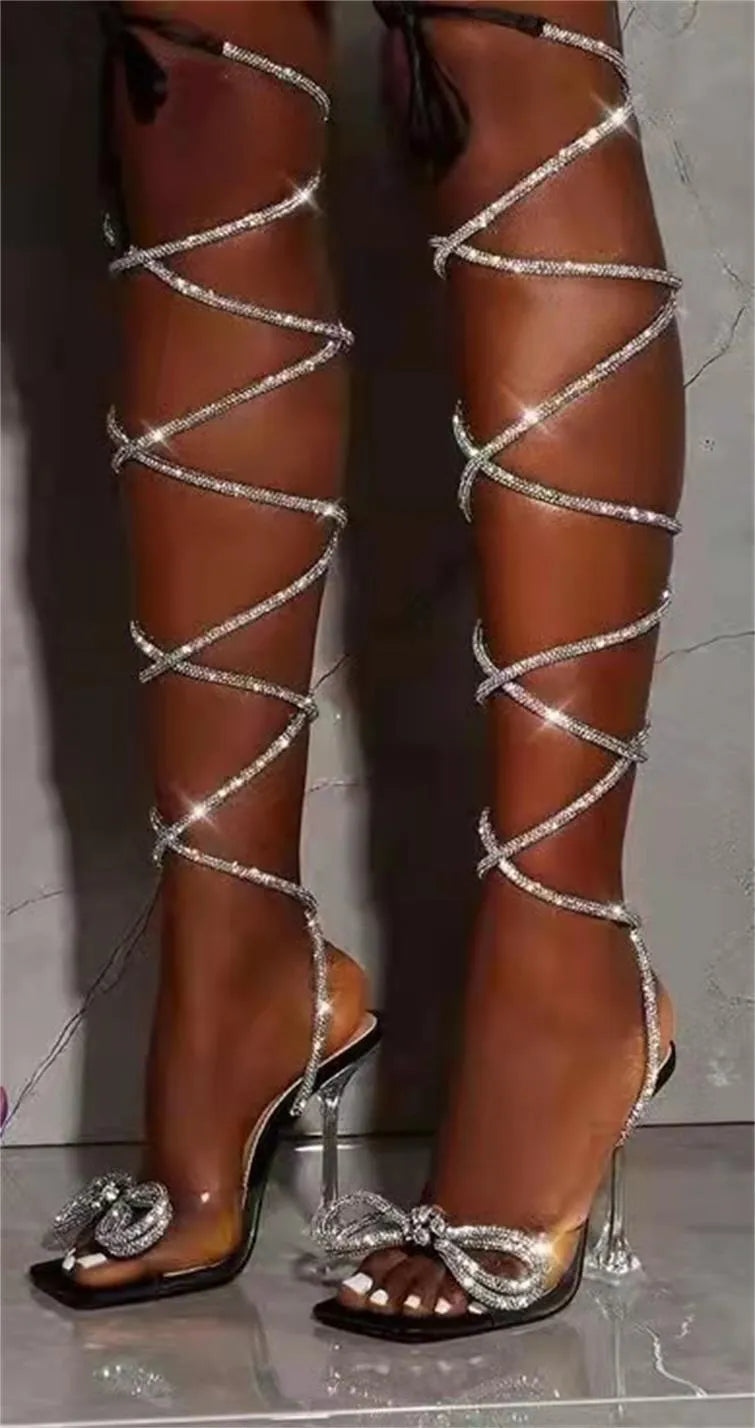Plus size women's black strappy sandals with Roman rhinestone strap detail and square toe.