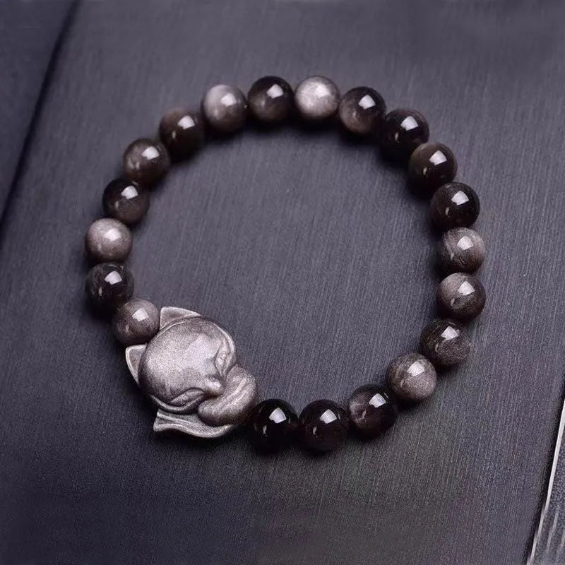 Obsidian fox charm bracelet on an adjustable leather cord for women.