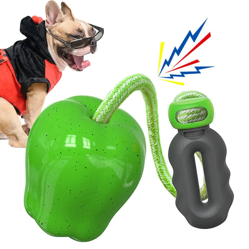 Plastic apple-shaped dog chew toy with molar texture and hollow centre for food dispensing.