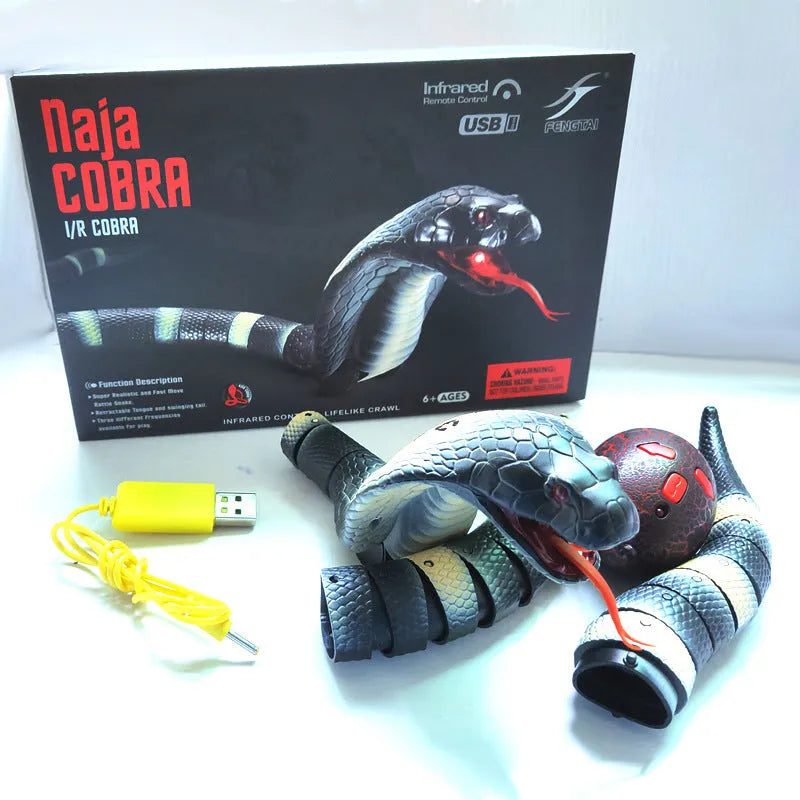 Smart sensing interactive electronic snake cat toy on a floor, showing segmented plastic body and USB charging port.
