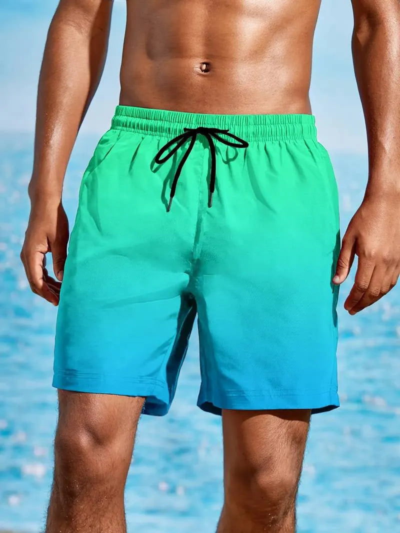 Man wearing grey gradient 3D printed mesh sports shorts against a plain background.