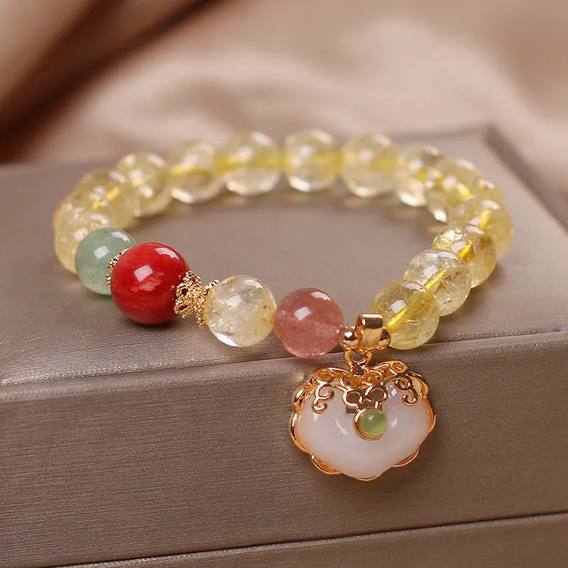 Women's pendant bracelet with a yellow natural citrine jade ruyi charm on an alloy chain.