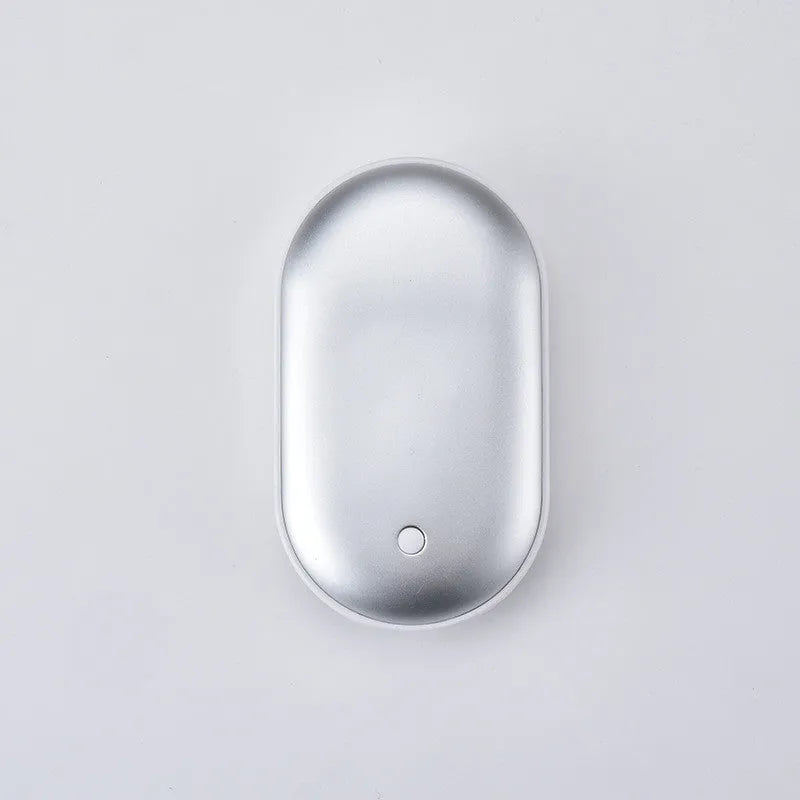 Compact rose gold USB rechargeable hand warmer and power bank with digital display, shown next to its charging cable.