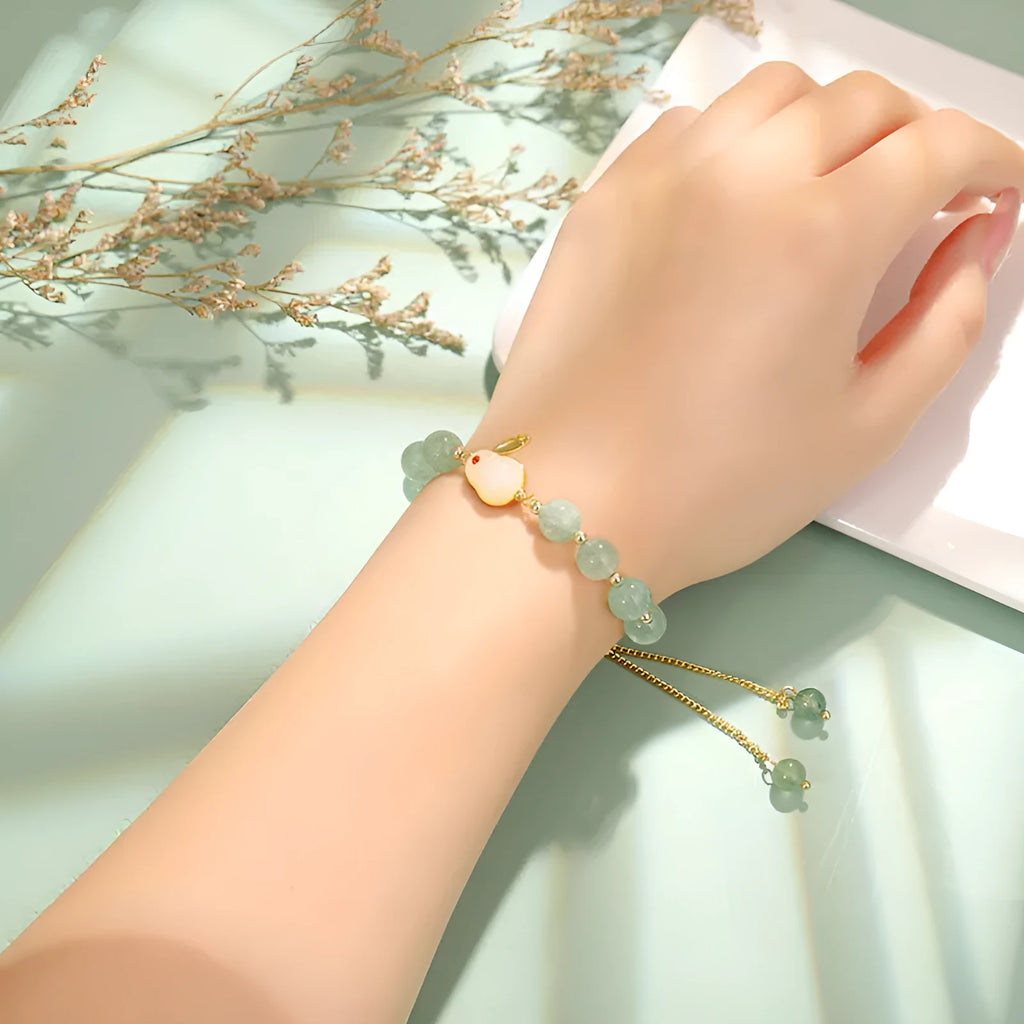 Green aventurine and strawberry quartz rabbit charm bracelet for women with copper and gold details