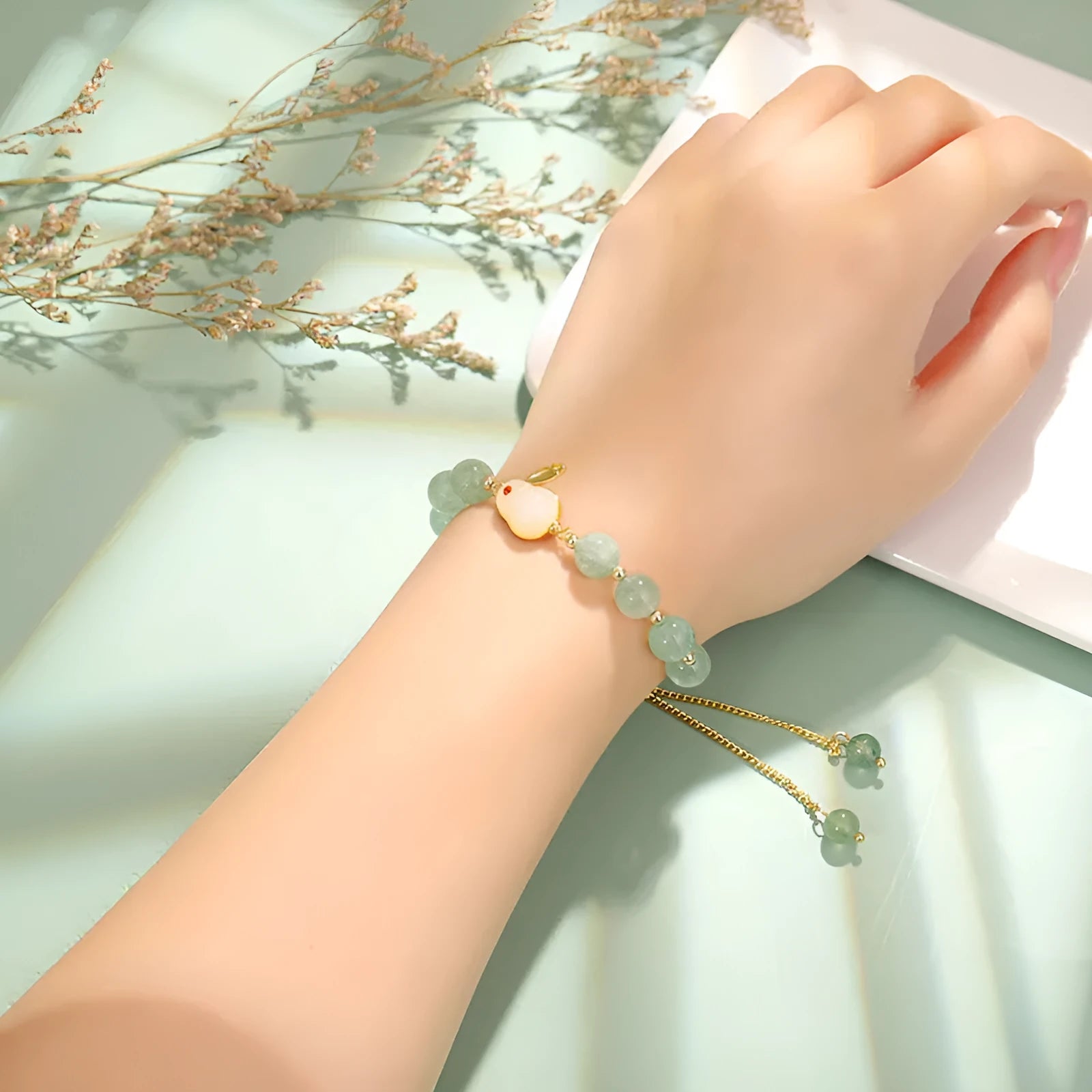 Green aventurine and strawberry quartz rabbit charm bracelet for women with copper and gold details