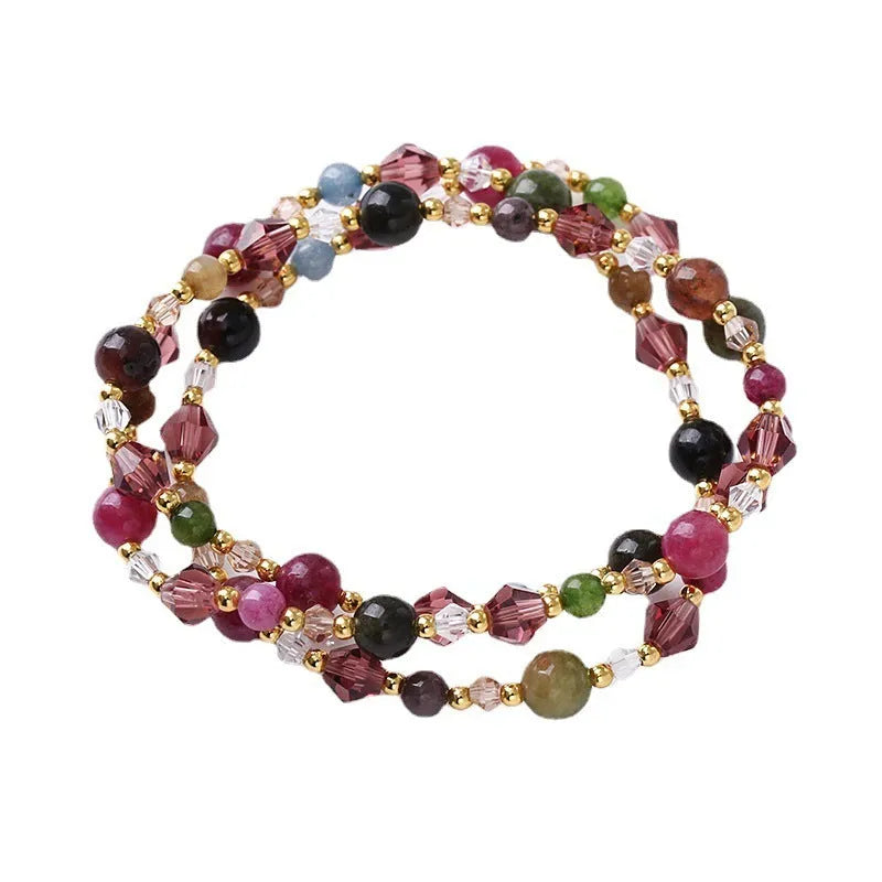 Women's adjustable bracelet with tourmaline, strawberry quartz, or amethyst crystal beads on a cord.