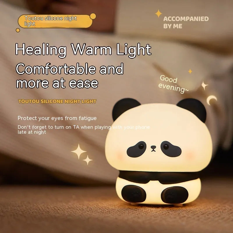 Panda LED night light with soft silicone head and colourful glow on a wooden table