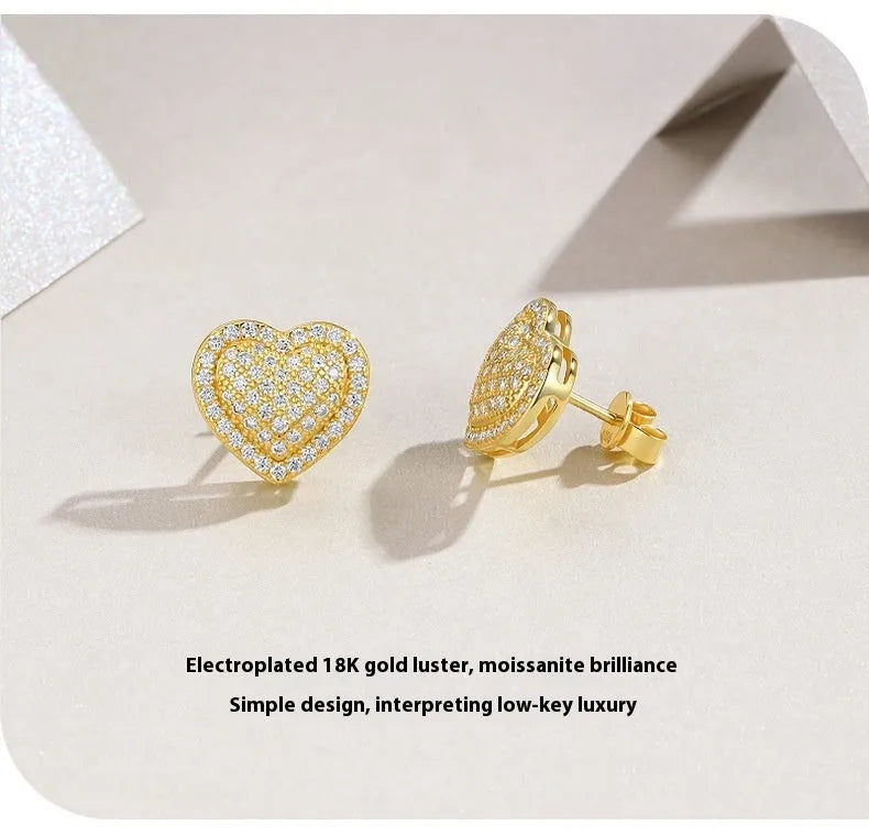 A pair of gold-coloured heart-shaped hoop stud earrings with moissanite stones on S925 sterling silver posts.