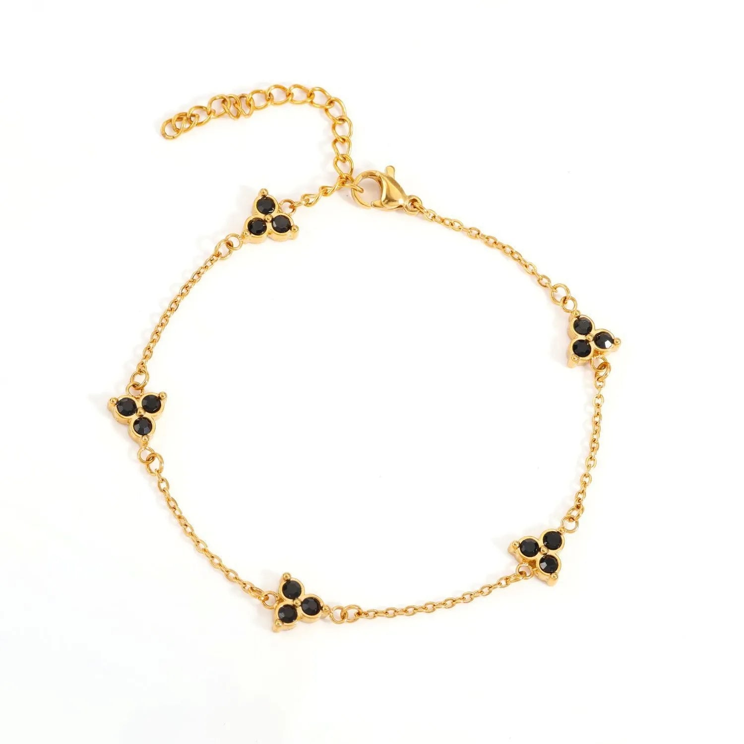 Women's stainless steel geometric bracelet with triangle design and three-diamond centrepiece in gold or steel finish.