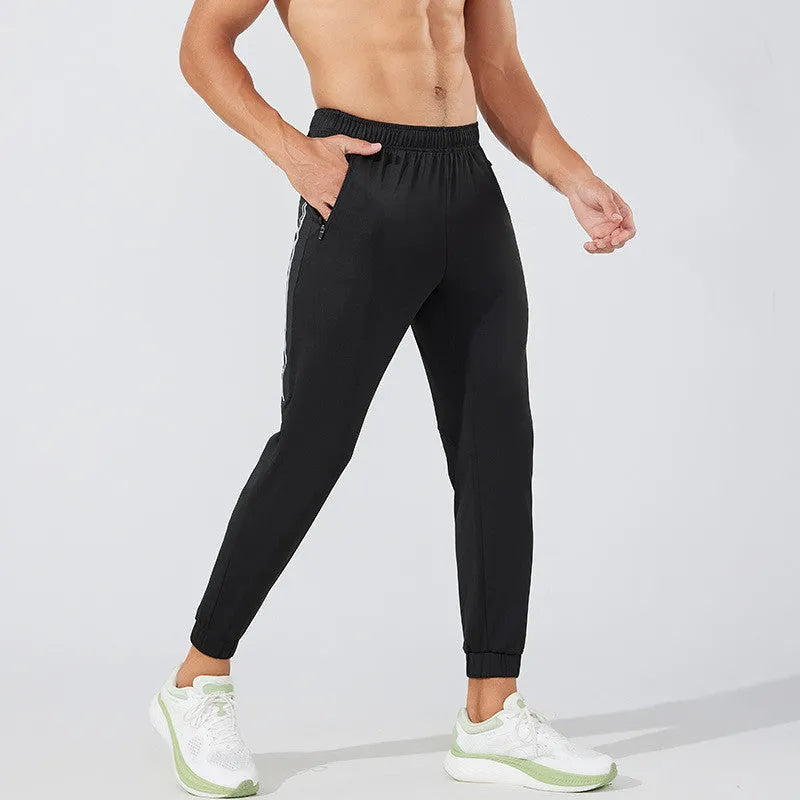 Men's black running trousers with mid waist design and breathable polyester construction for spring exercise