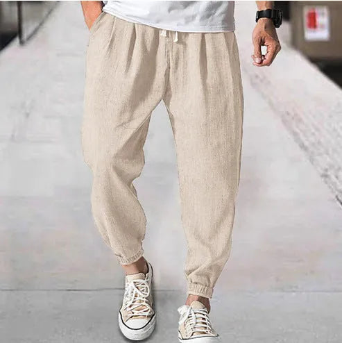 Men's cotton ankle banded trousers in light green colour showing loose fit and summer casual styling