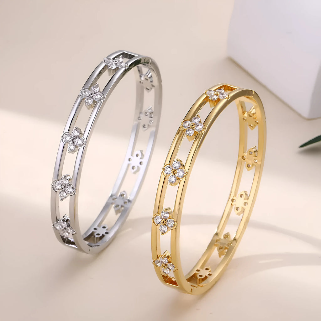 Women's hollow bracelet with zircon stones and four-leaf clover charm in gold and silver options