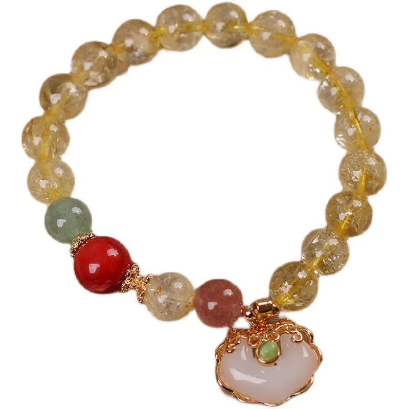 Women's pendant bracelet with a yellow natural citrine jade ruyi charm on an alloy chain.