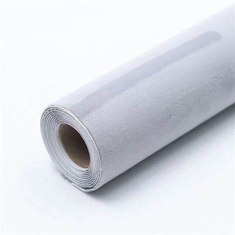 Rolls and sheets of coloured self-adhesive suede leather material for DIY projects.