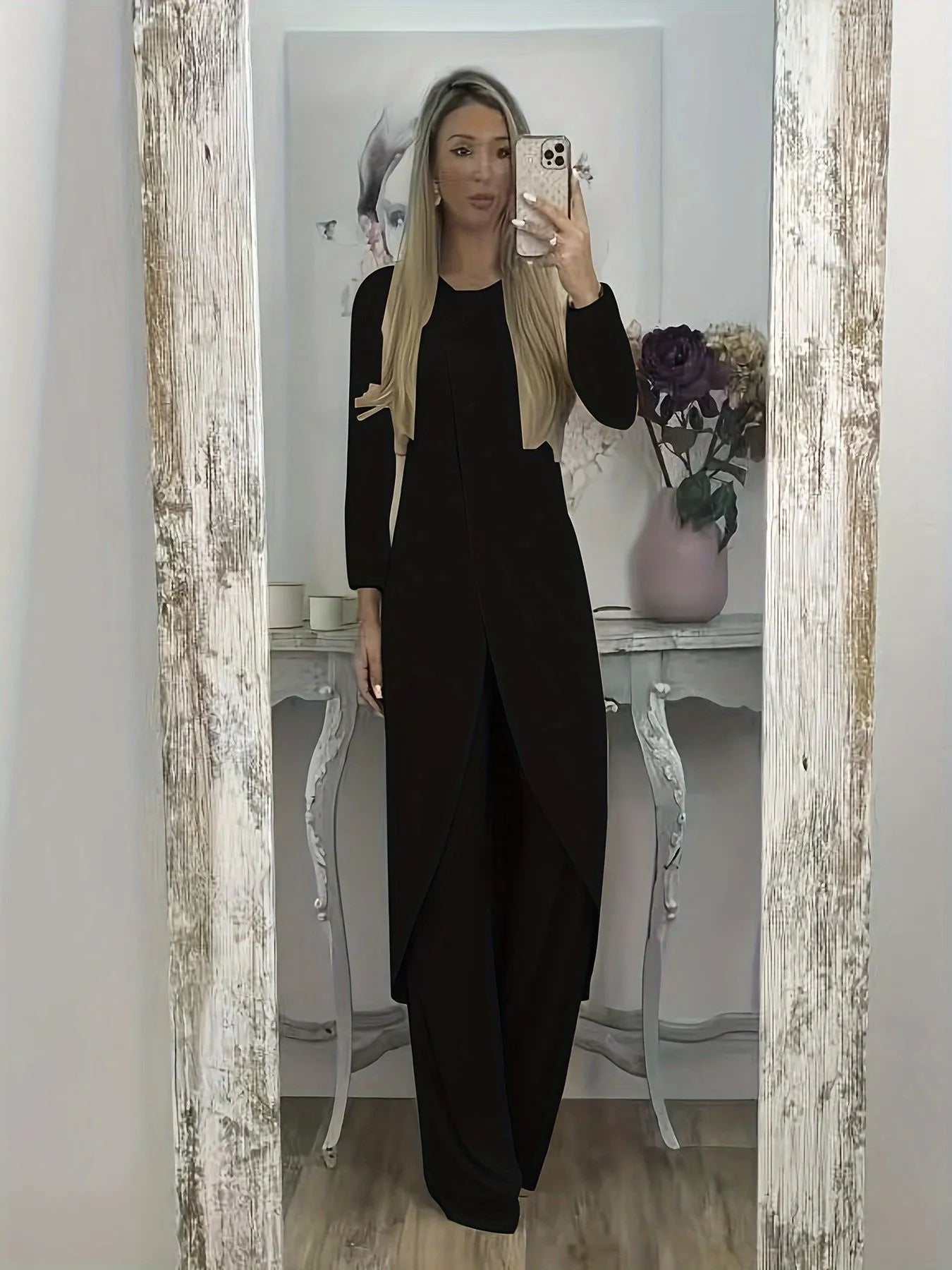 Casual black polyester two-piece lounge set with long sleeve top and loose trousers on a hanger.