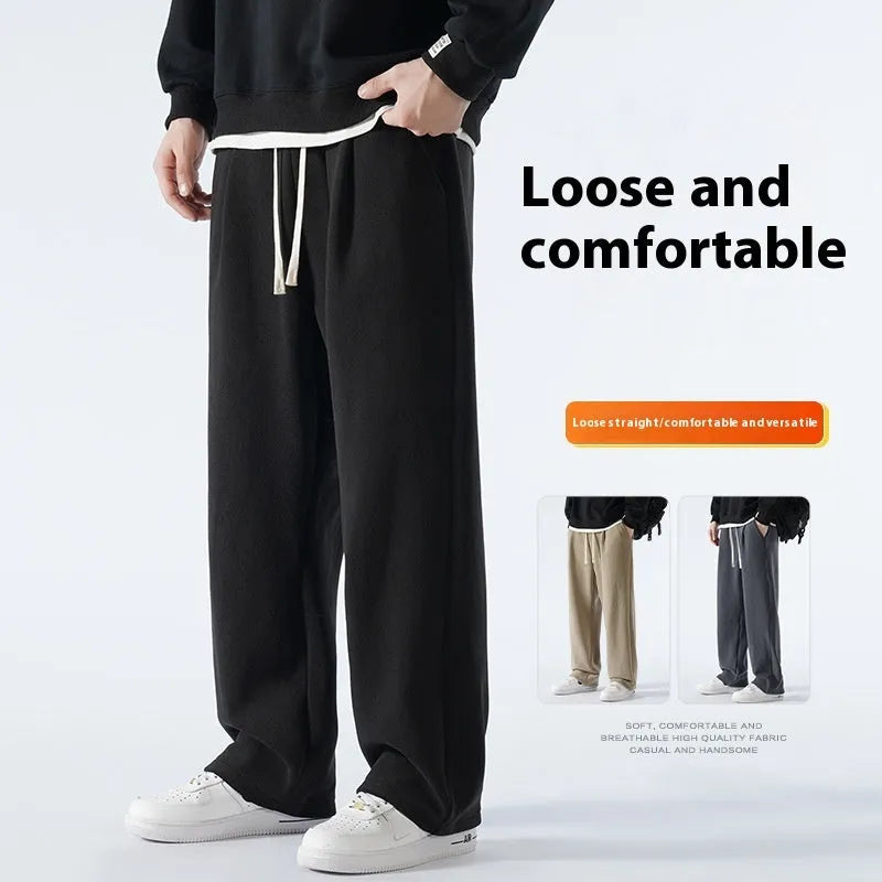 Men's double-sided polar fleece sports trousers in apricot, showing loose fit and drawstring waist.