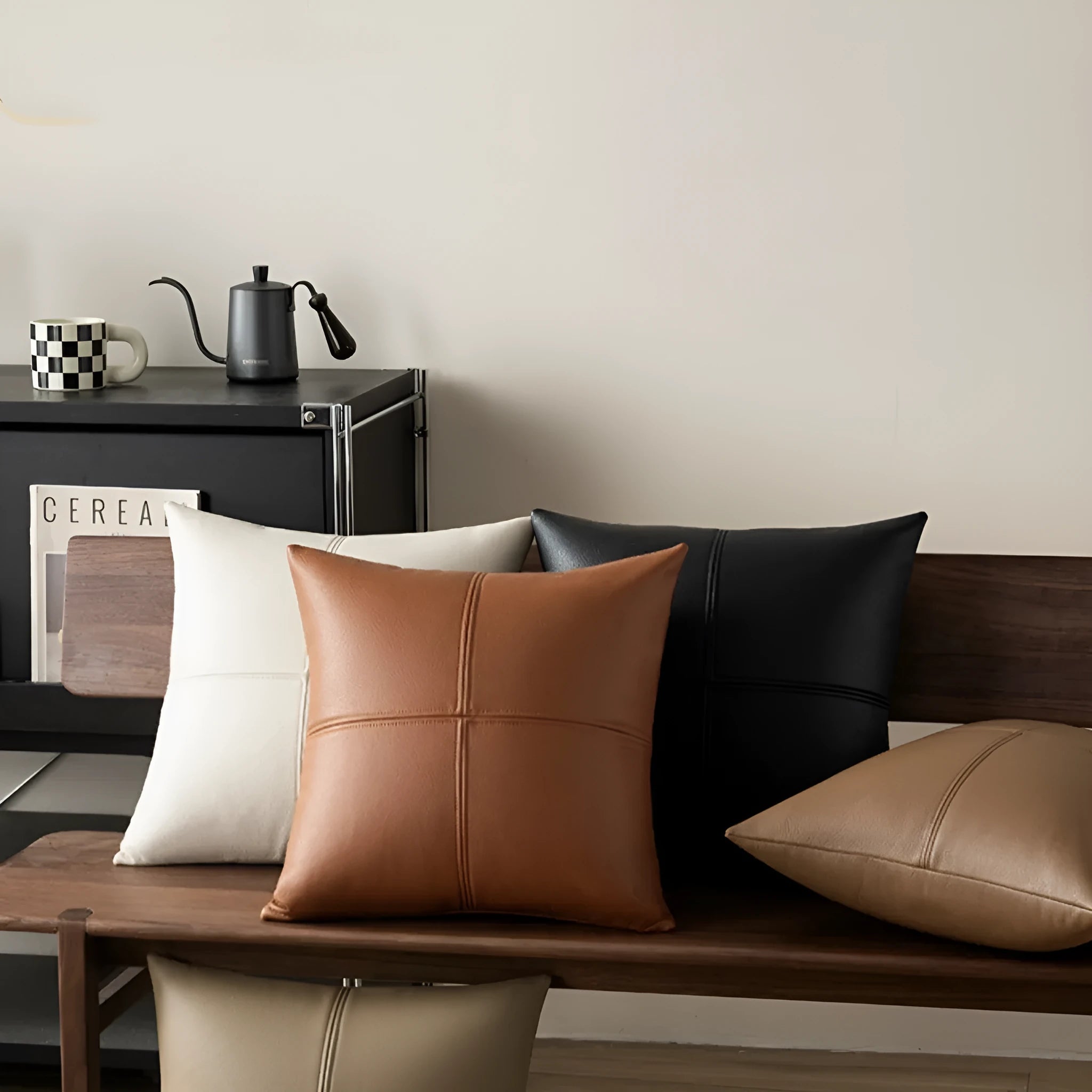 Simple solid colour cowhide leather pillow cover on a sofa, shown in a beige white colour.