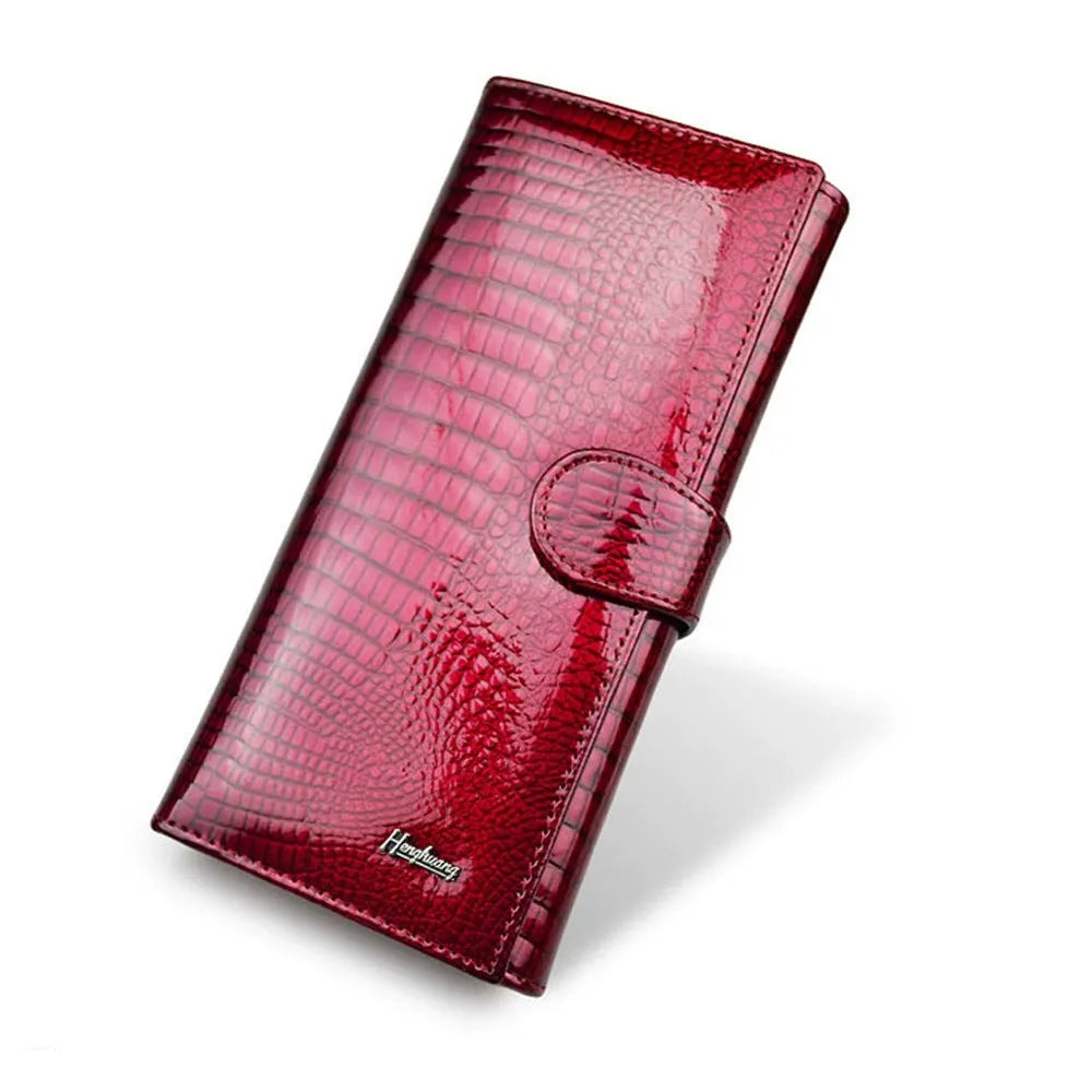 Women's red patent leather coin purse with embossed crocodile pattern texture.