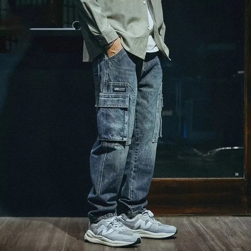 Men's blue loose straight-leg stretch denim trousers with elastic waistband and zip fly placket