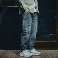 Men's blue loose straight-leg stretch denim trousers with elastic waistband and zip fly placket