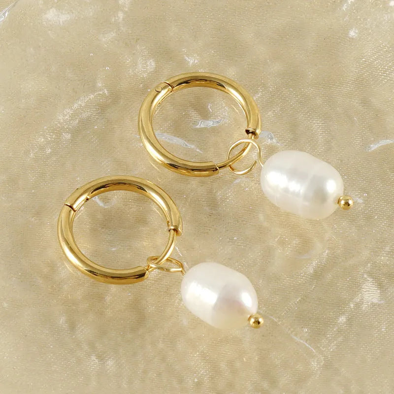 Pair of gold geometric earrings with pearl detail on titanium steel posts