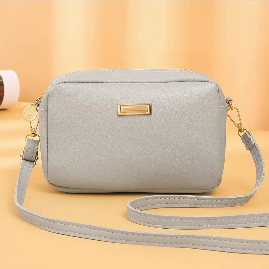 Solid colour PU women's shoulder bag showing three-dimensional pocket, in horizontal square shape.