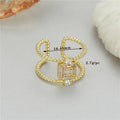 Adjustable open mouth copper ring with asymmetric U-shape and gold plating.