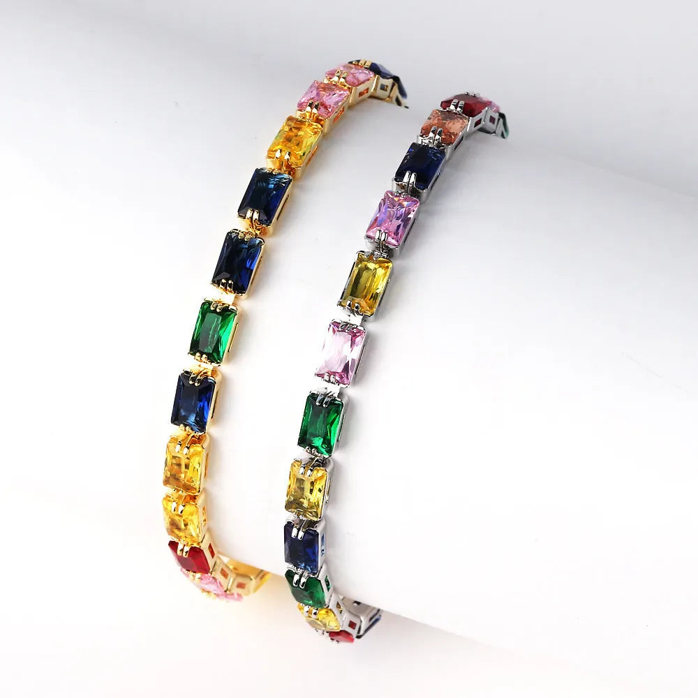 Adjustable electroplated zircon bracelet in gold finish with coloured zircon accents