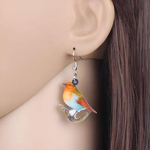 Blue Titmouse pendant earrings with geometric and snake designs on acrylic
