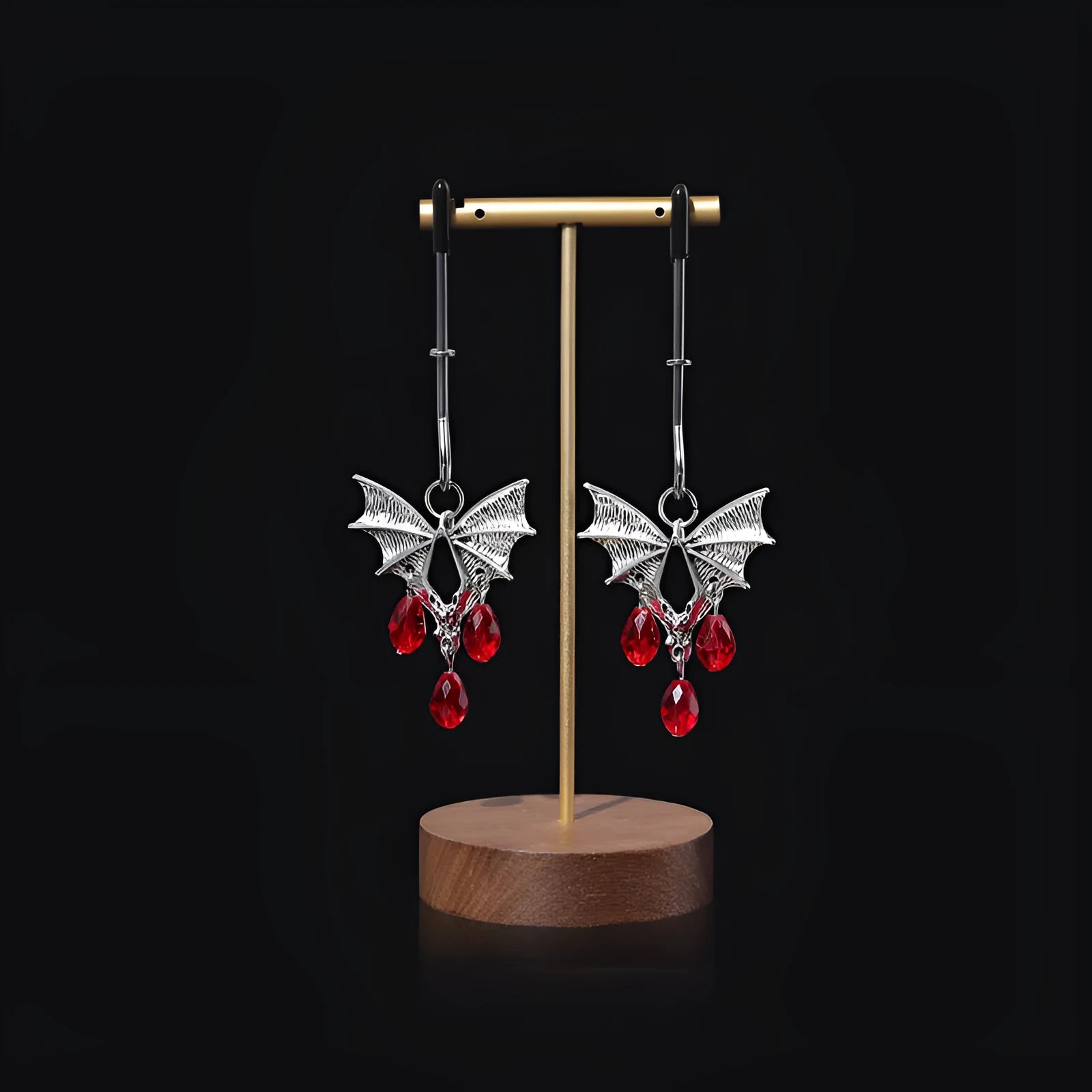 Silver alloy bat nipple clamp with ruby design showing adjustable pressure mechanism