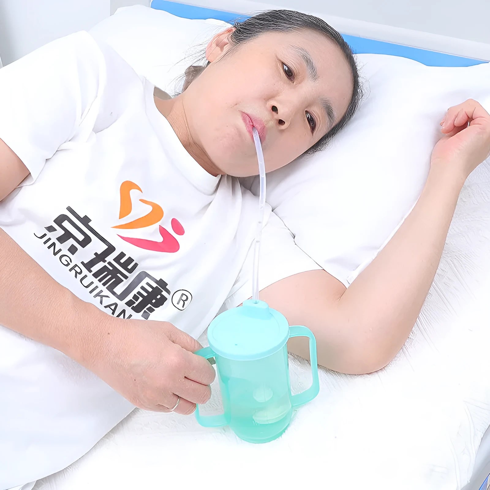 Adult bed drinking cup with oblique anti-choke mouth design and optional wrist splint attachment