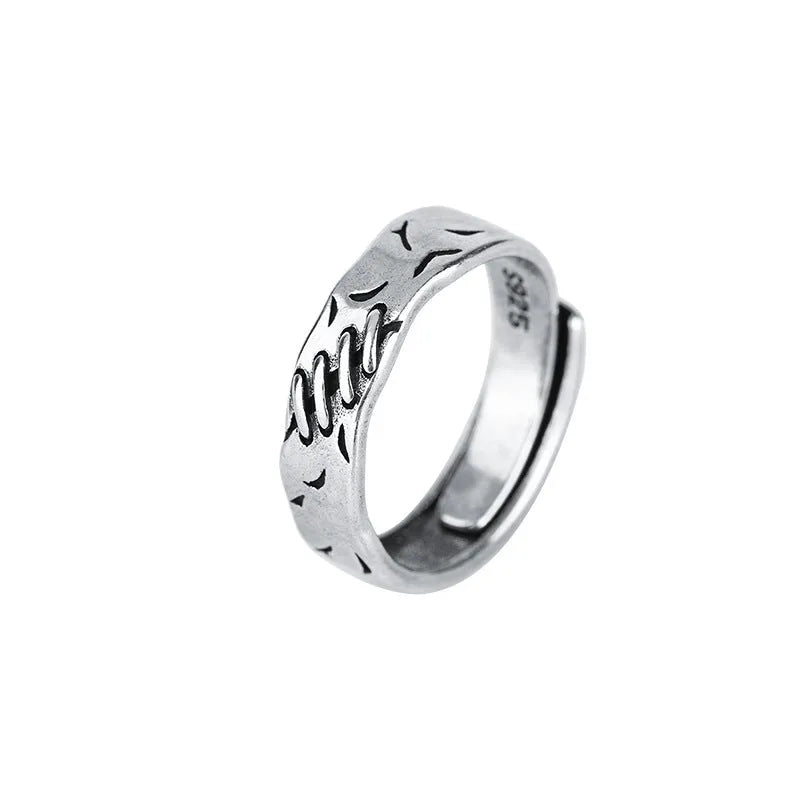 Black geometric adjustable ring with round and oval elements on copper base